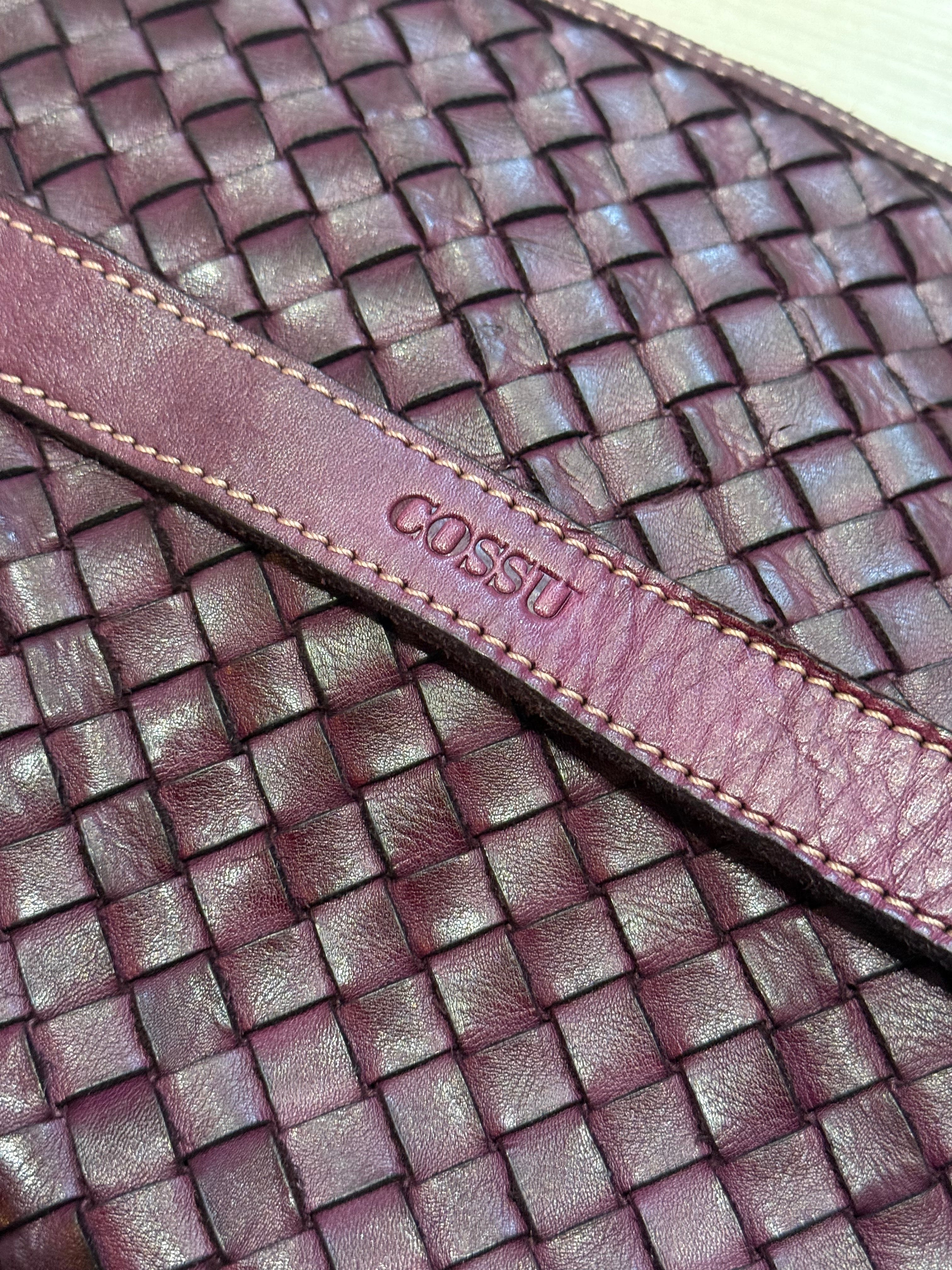 Close up of logo Cossu handwoven Leather handbag inspired by classic Italian brands
