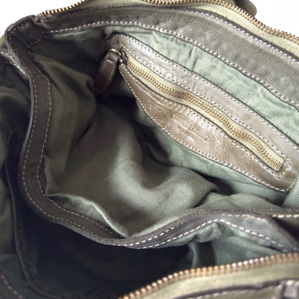 Showing an inside zipped pocket of an olive green handwoven Italian leather pouch Italian leather crossbody handbag in soft neutral leather